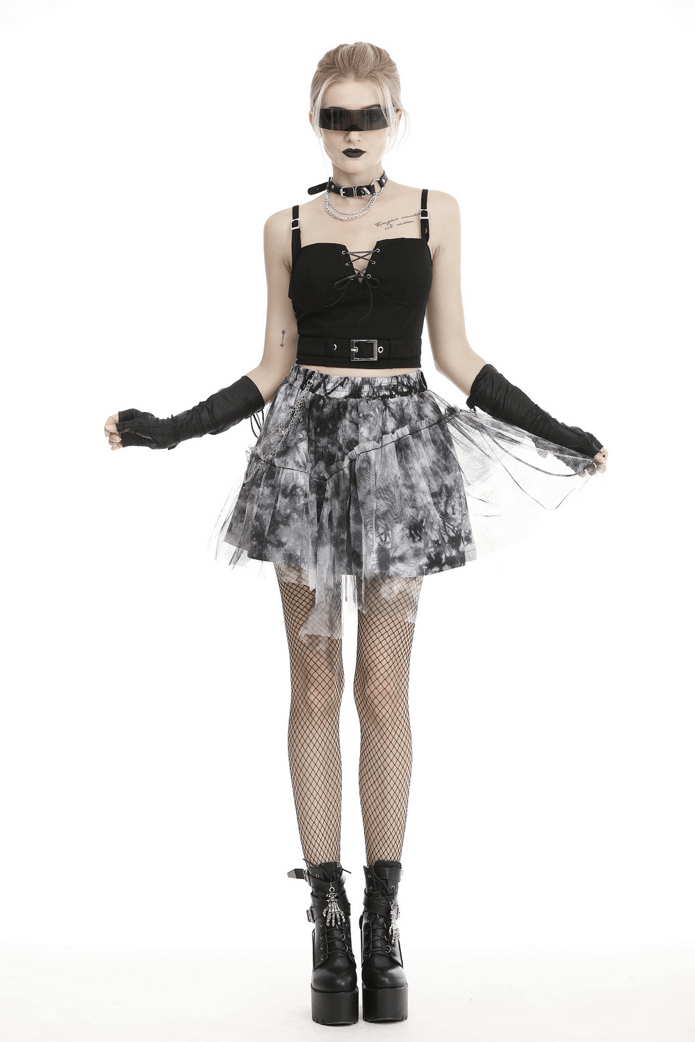 Chic marble print skirt with a trendy edgy outfit, featuring black top, accessories, and stylish boots for a bold look.