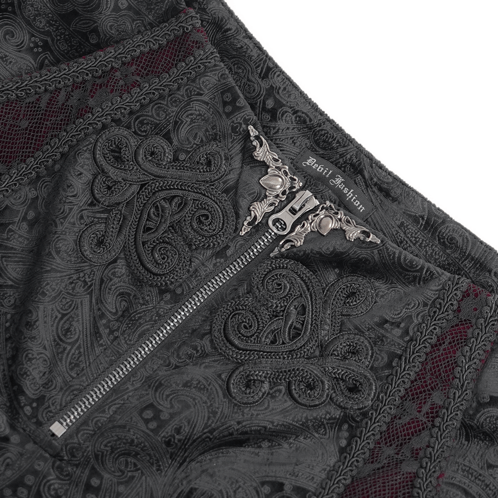 Close-up of stylish black jacquard pants featuring intricate lace details and ornate zipper closure for a chic look.