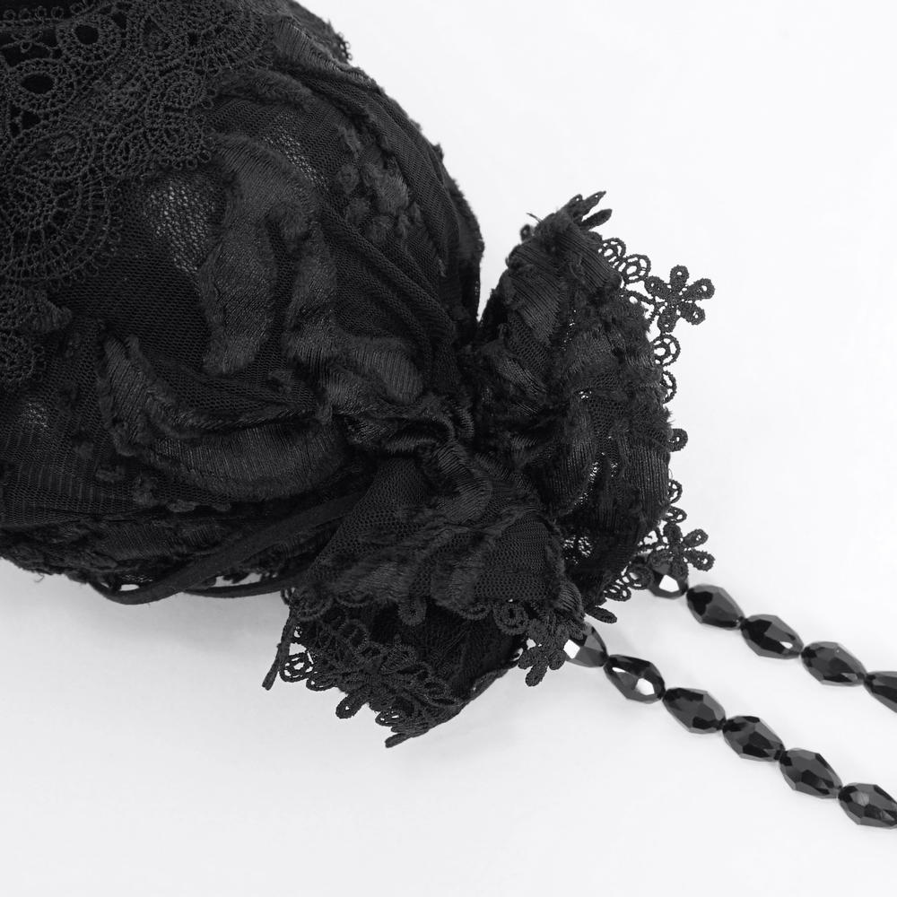 Chic black lace evening bag with bead-chain strap, featuring intricate lace detailing and elegant bow design.
