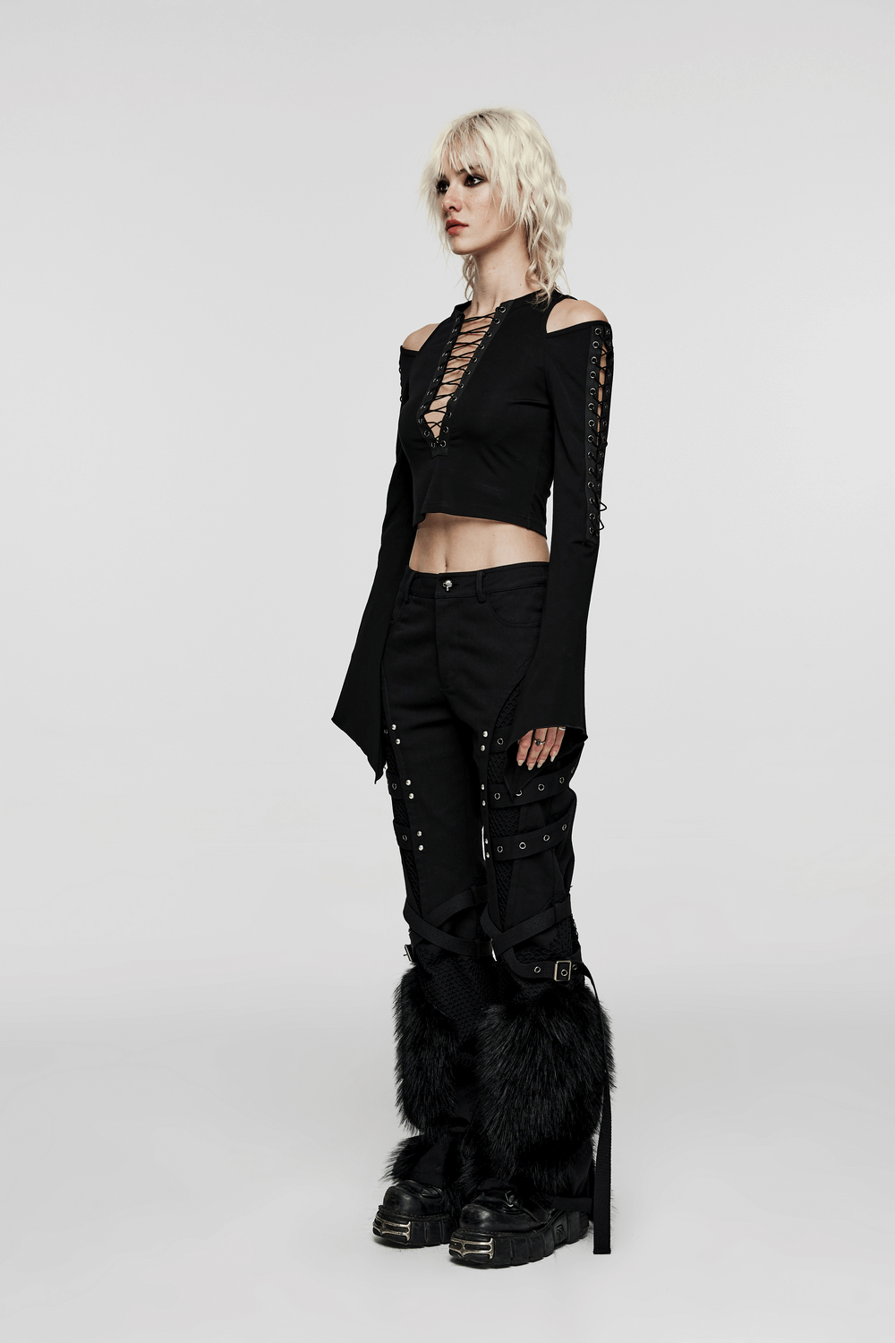 Chic off-shoulder goth top with lace-up detailing and stylish high-waisted pants, perfect for edgy fashion lovers.