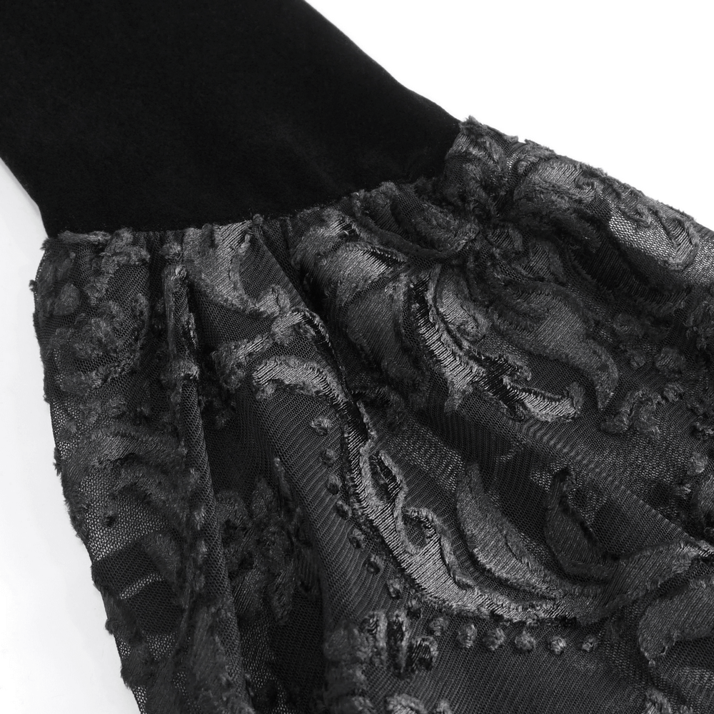 Close-up of sheer black lace fabric with intricate patterns and elegant bell sleeve detail.