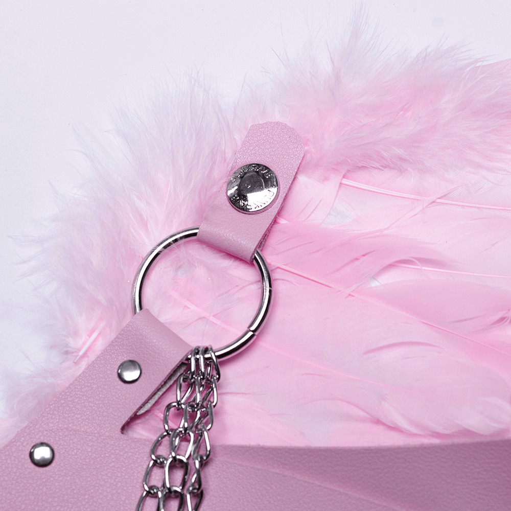 Close-up of pink feathered wings harness featuring silver chains and studs, perfect for festive events.