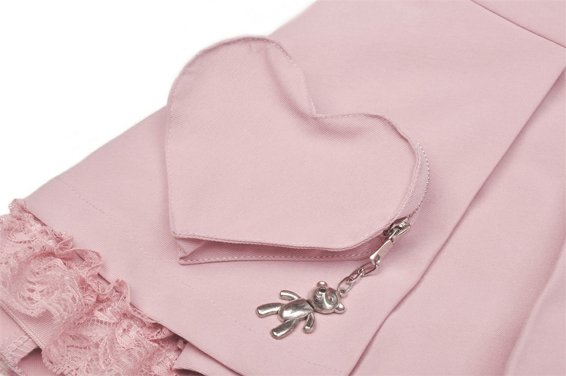 Chic pink pleated skirt detail featuring lace trim and a cute heart-shaped pocket with teddy bear charm.