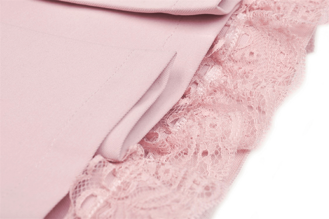 Close-up of a chic pink pleated skirt featuring delicate lace trim, perfect for stylish outfits.