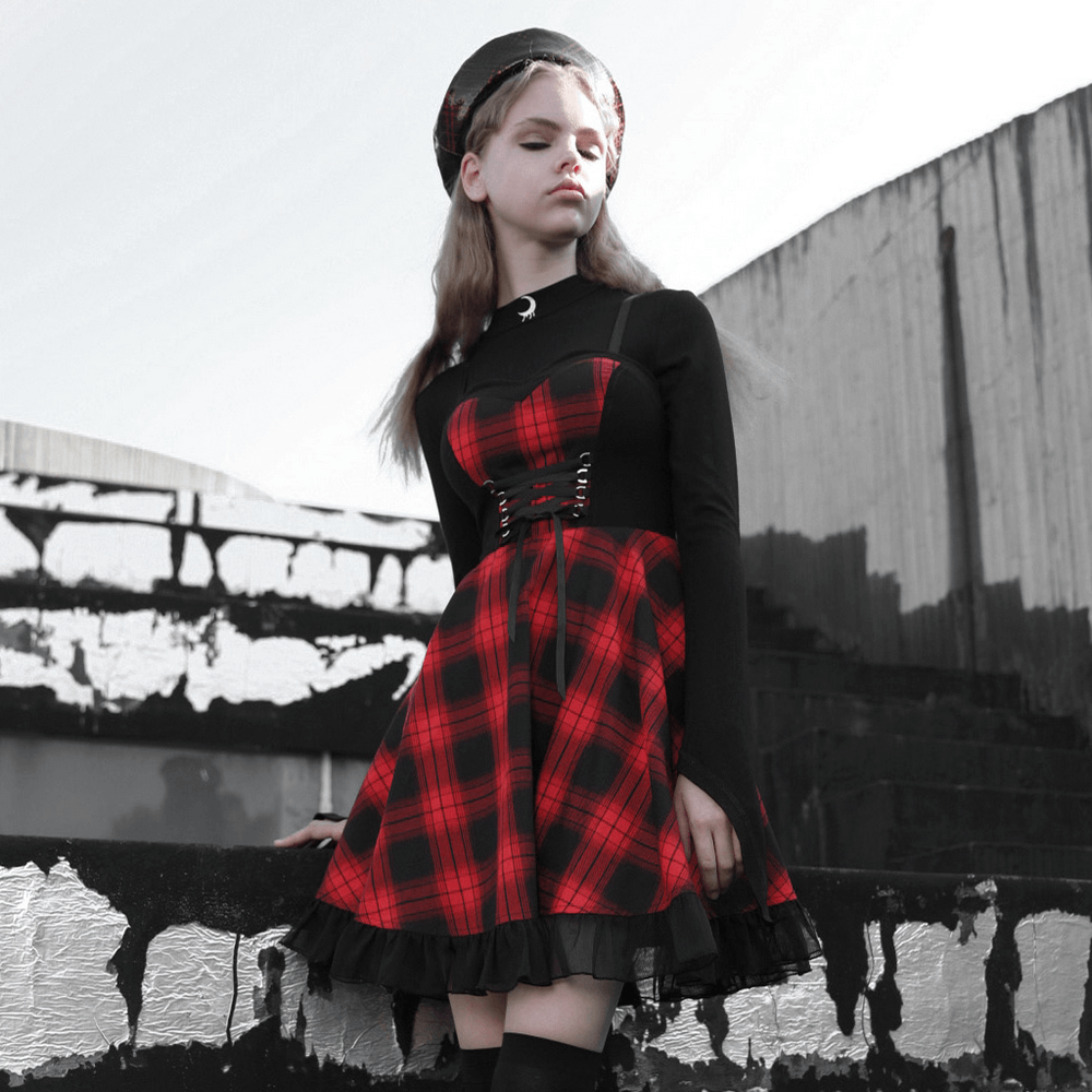 Chic plaid A-line dress with lace trim and waist detail, featuring a stylish black top and red plaid skirt.