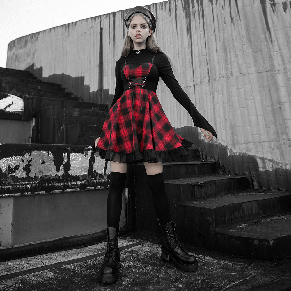 Chic plaid A-line dress with lace trim, stylishly paired with knee-high boots on urban stairs.