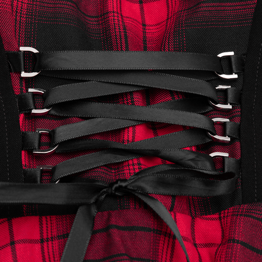 Close-up of the lace-up waist detail on a chic plaid A-line dress with contrasting black straps.