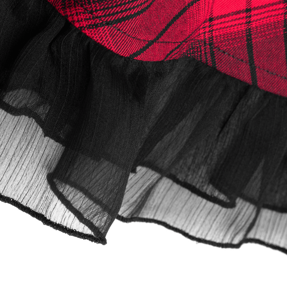 Close-up of the lace trim on a chic plaid A-line dress, showcasing its elegant black ruffle detailing.