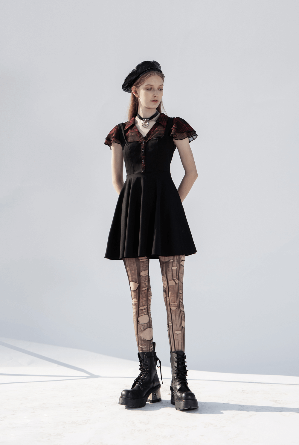 Chic Gothic A-Line dress with falbala sleeves, styled with leggings and chunky boots, perfect for a unique fashion statement.