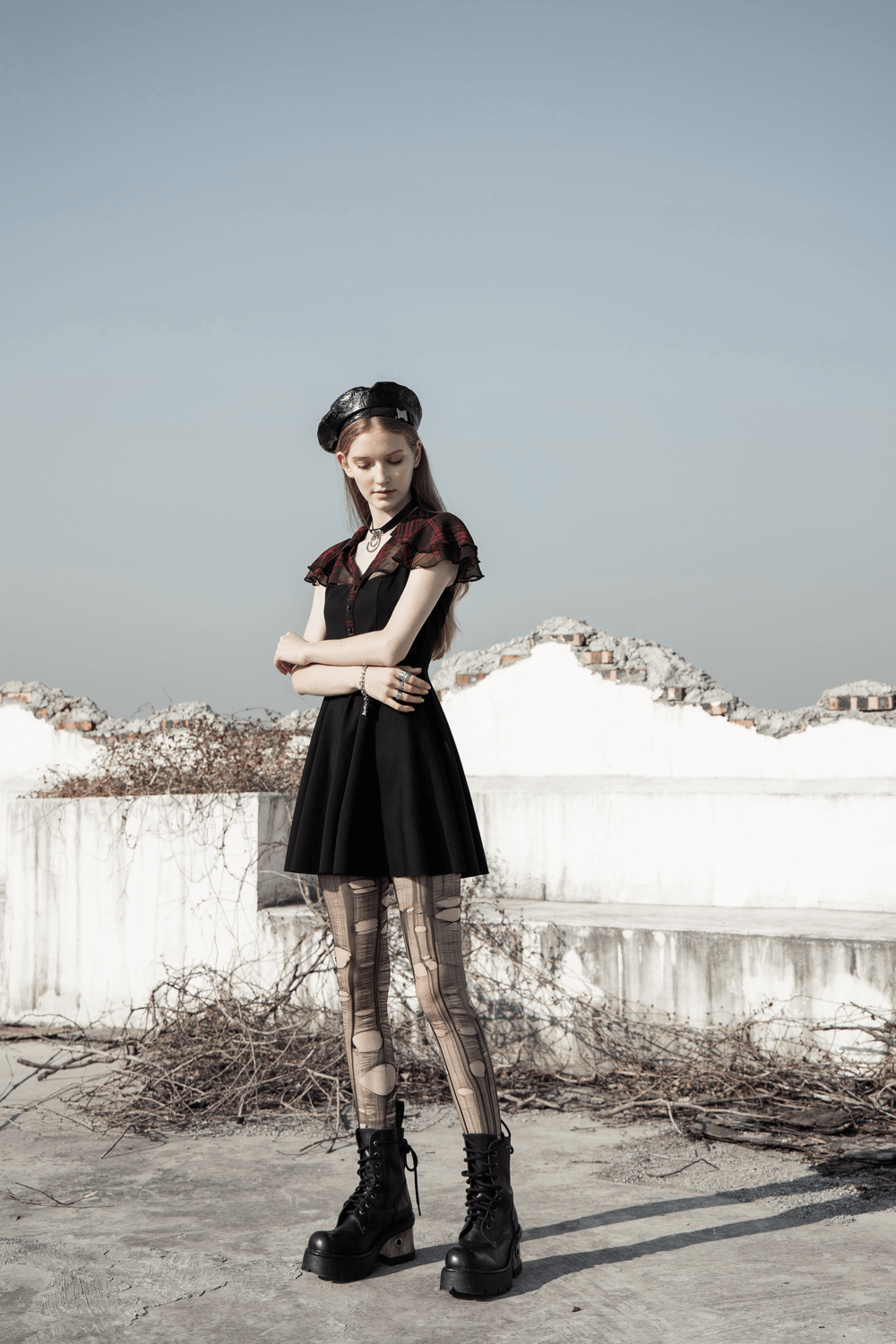 Chic gothic A-line dress with falbala sleeves, modeled against a serene backdrop, showcasing unique style and confidence.