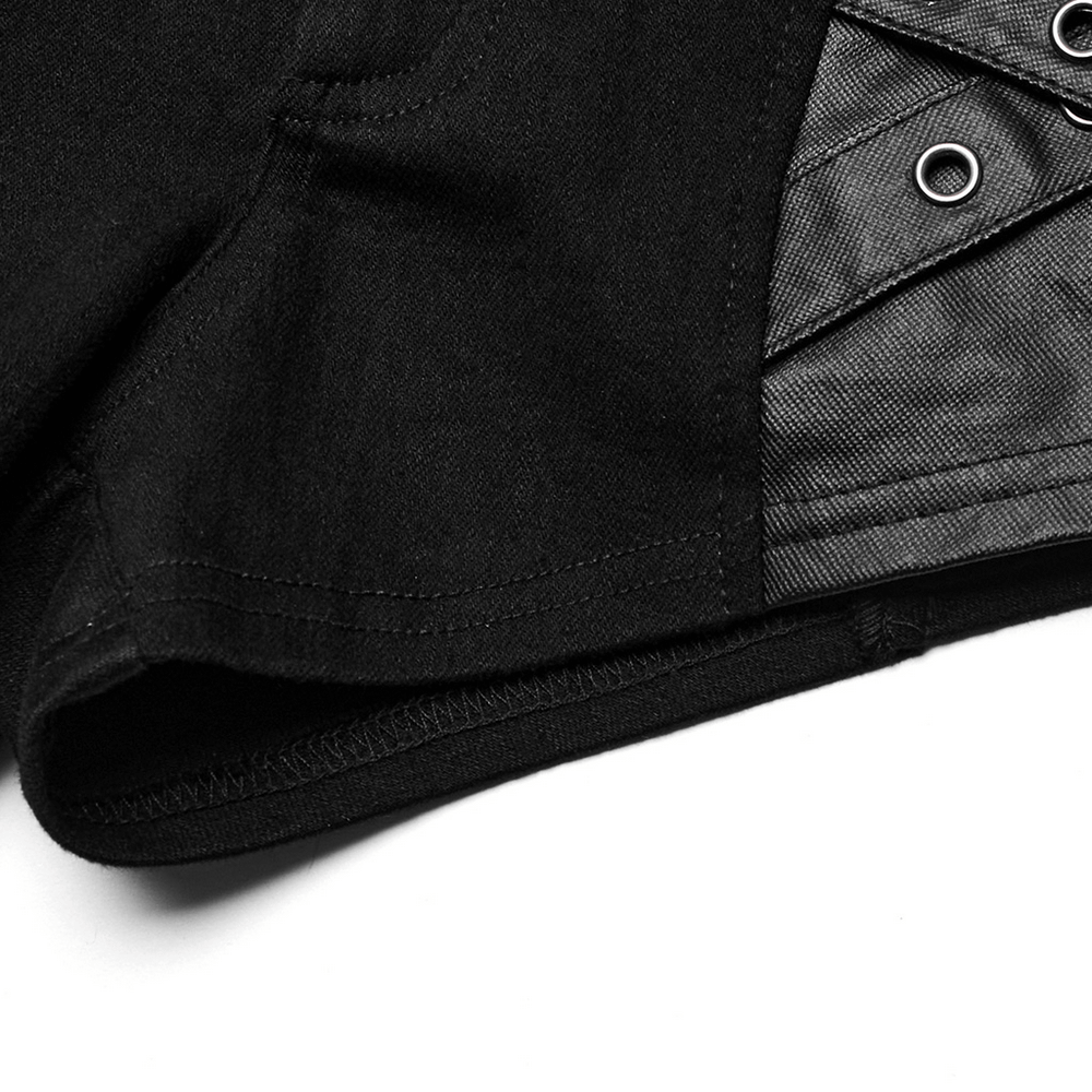 Close-up of chic punk rivet-embellished black denim shorts showcasing eyelet details and stretch fabric.