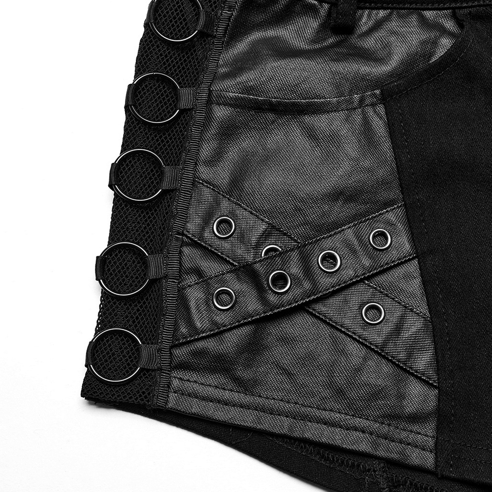 Close-up of chic punk black denim shorts with eyelet details and metal ring embellishments.