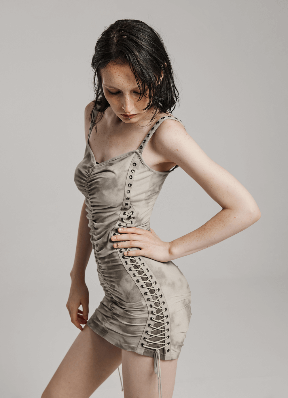 Chic punk tie-dye bodycon dress with drawstrings and eyelets, showcasing edgy style and flattering fit.