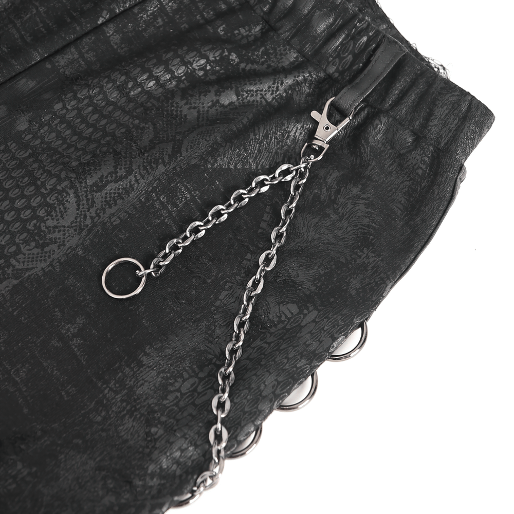 Close-up of black snake print skinny leggings showcasing chain detail for women.