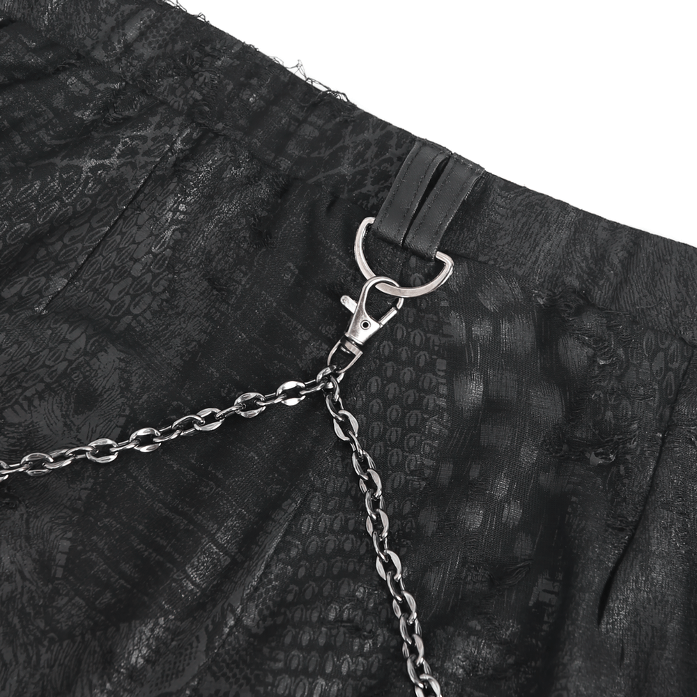 Close-up of chic black snake print leggings with edgy chain detail for women.