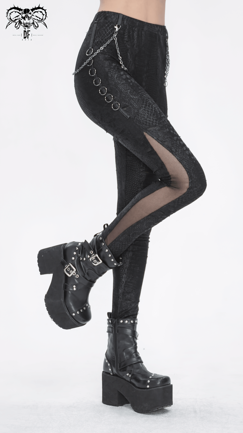 Chic black snake print leggings with chain detail and mesh inserts, styled with edgy platform boots.