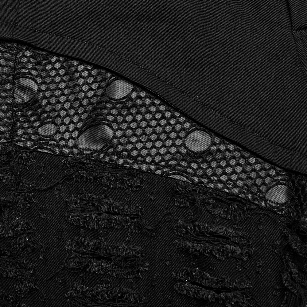 Close-up of chic ripped mesh fabric on gothic style trousers for women, showcasing detail and texture.