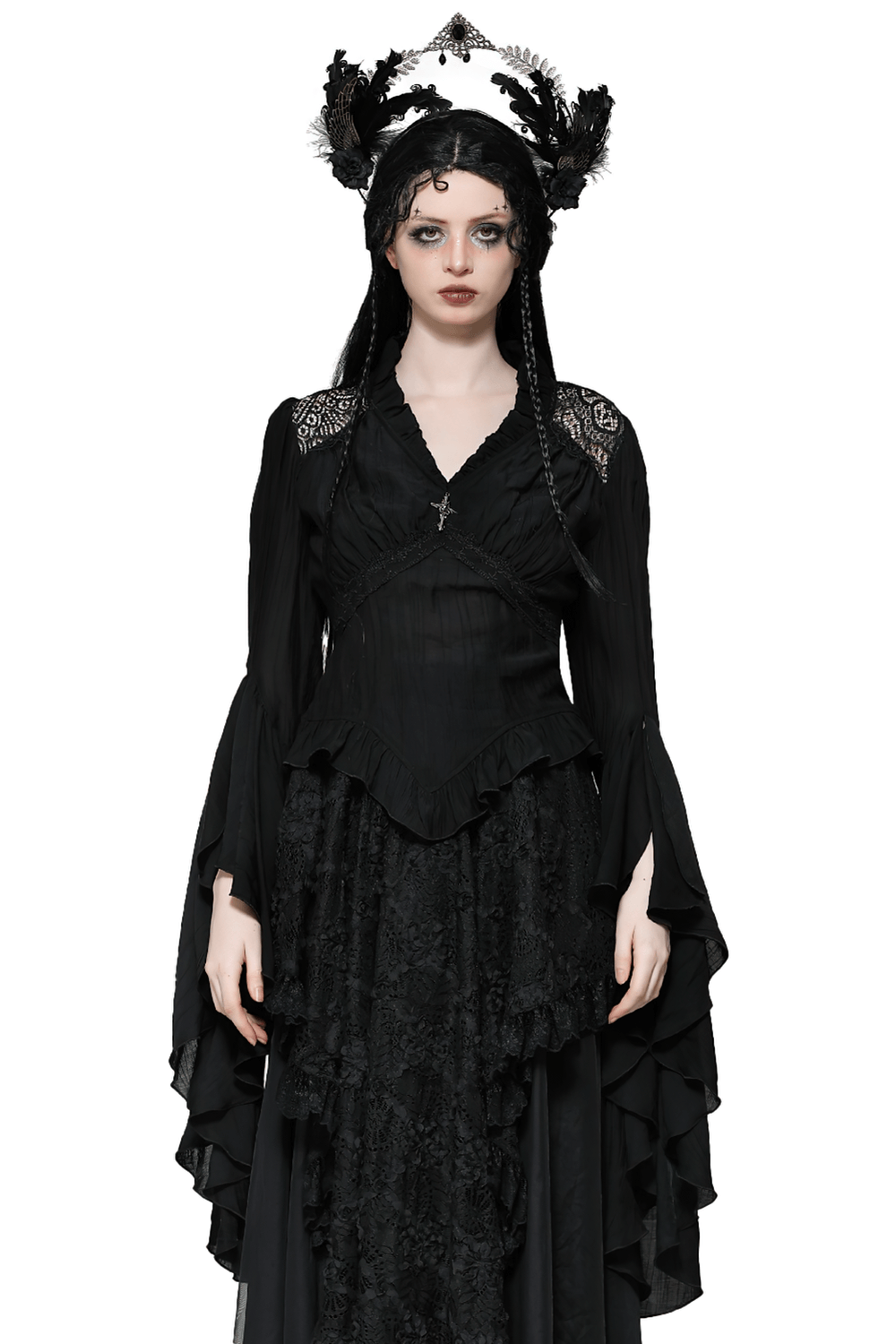 Black gothic ruffled top with bell sleeves, lace details, and brooch, modeled with a dramatic flair. Perfect for alternative fashion lovers.