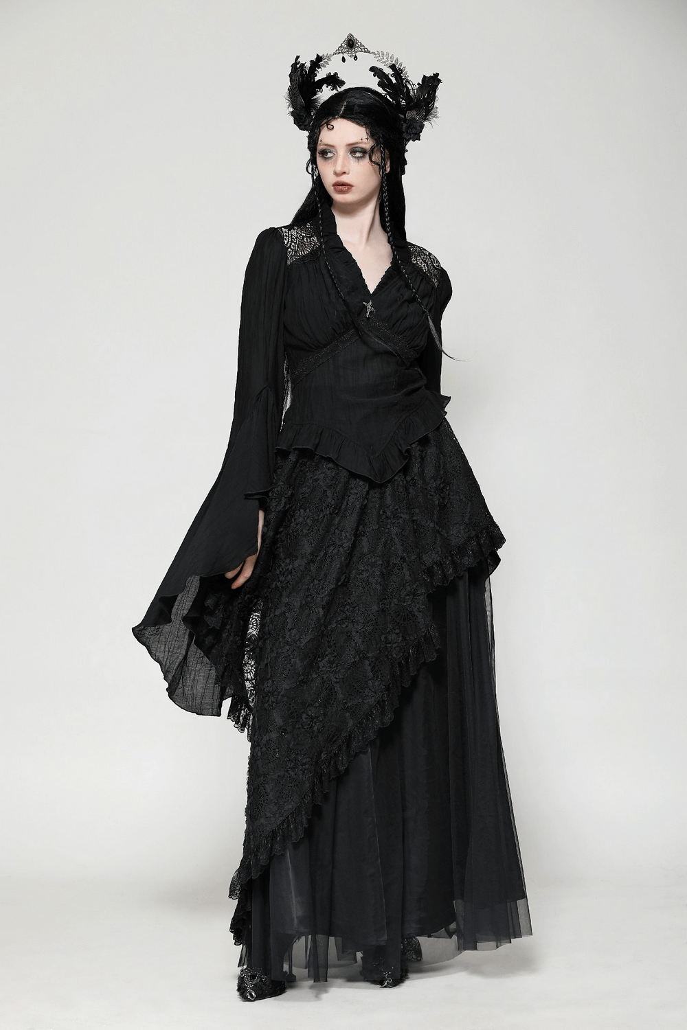 Elegant Gothic top with ruffled bell sleeves, lace detailing, and vintage brooch, styled with dramatic flair and alternative fashion charm.