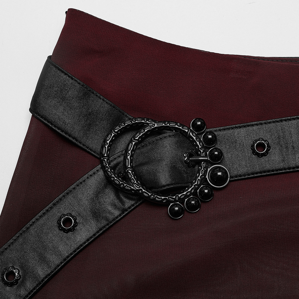 Close-up of the black belt with circular buckle on a chic sheer maxi skirt, perfect for edgy, stylish looks.