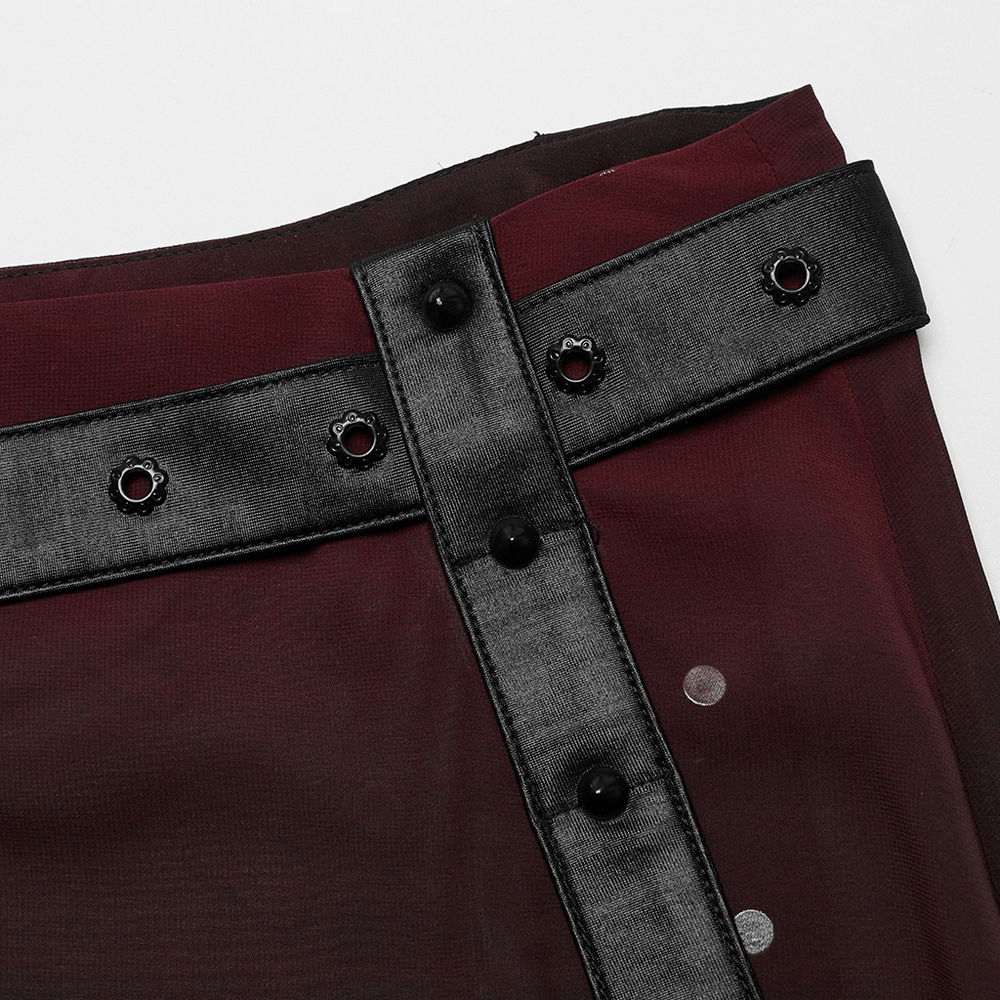 Close-up of the chic belt detail on a sheer maxi A-line skirt, featuring buttons and edgy style elements.