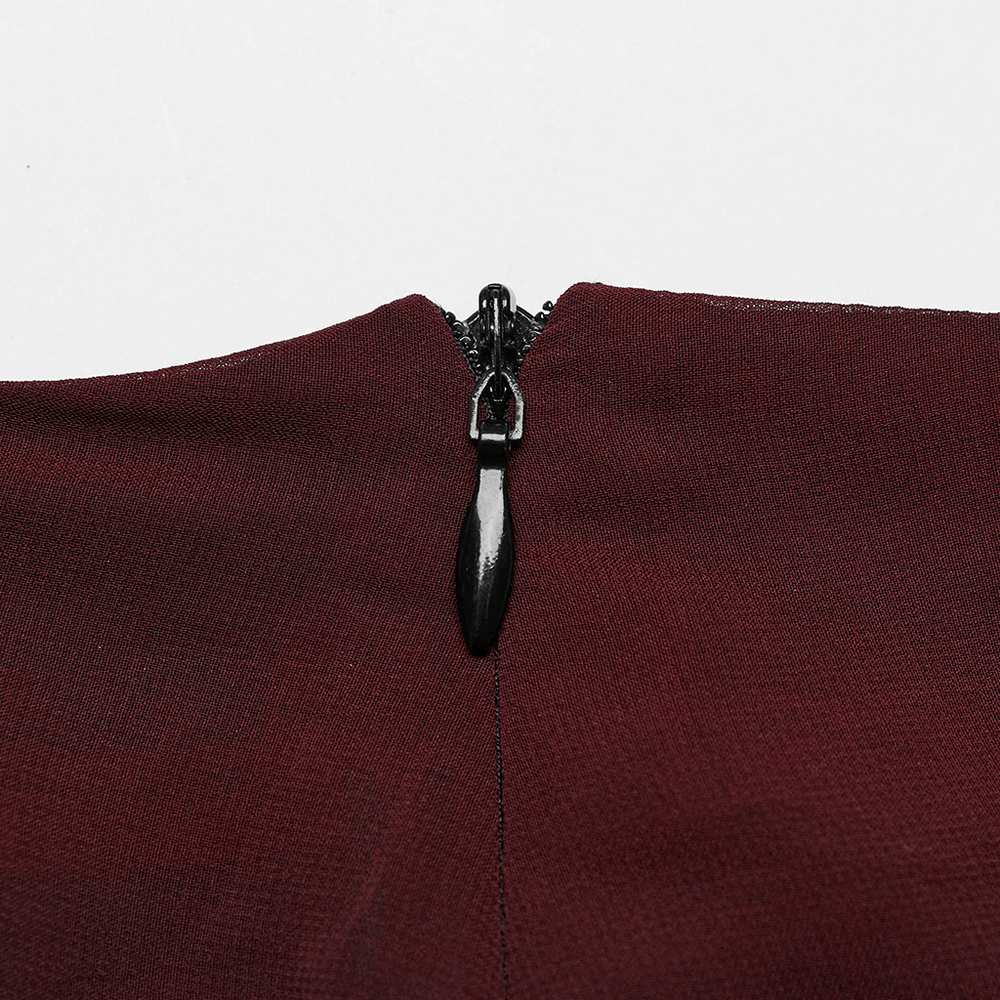 Close-up of zipper detail on burgundy chic sheer maxi skirt, highlighting style and quality.