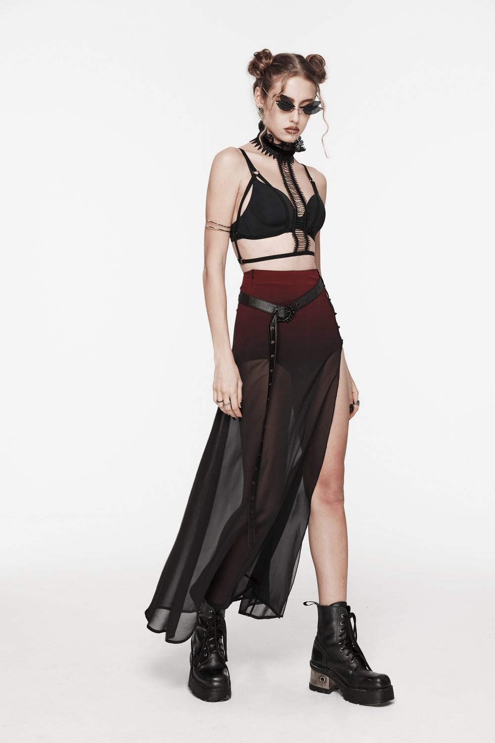 Model showcasing chic sheer A-line maxi skirt with high slit, paired with edgy crop top and combat boots.