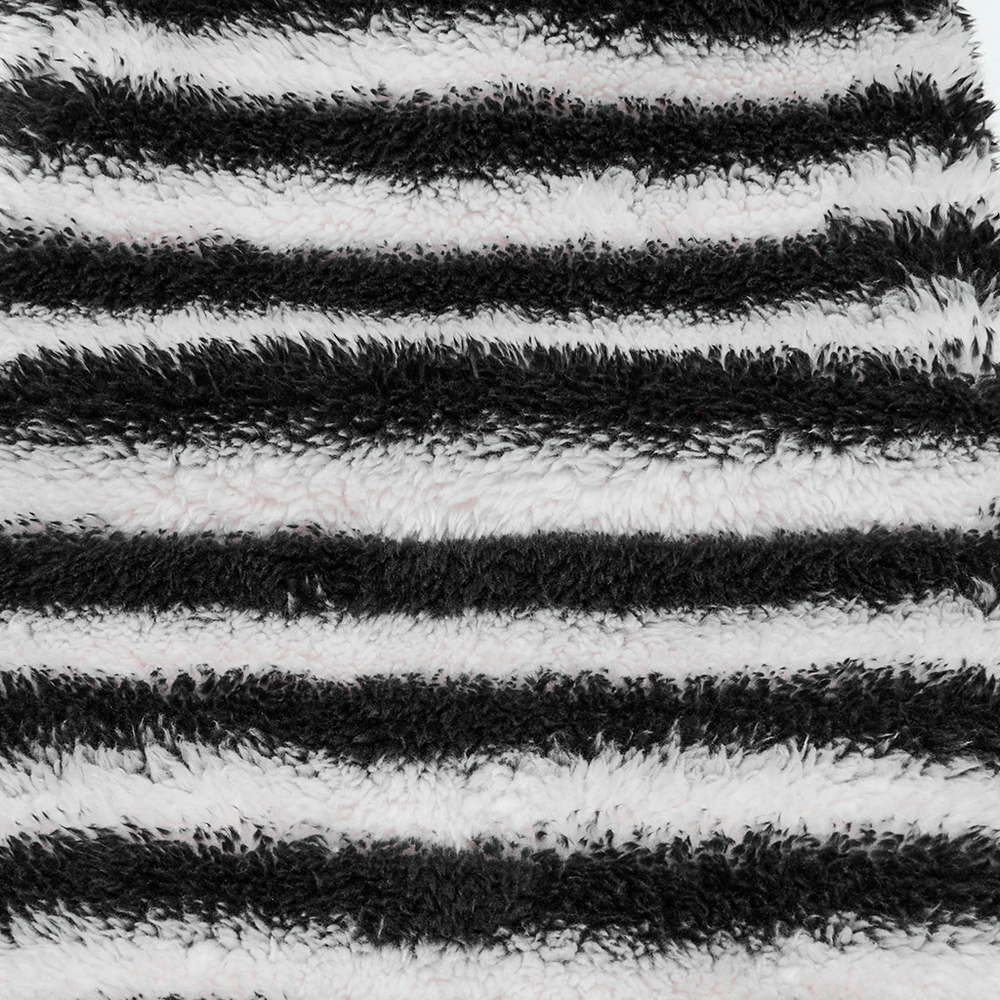 Chic striped plush leg warmers featuring soft black and white stripes, perfect for cozy styling and warmth.