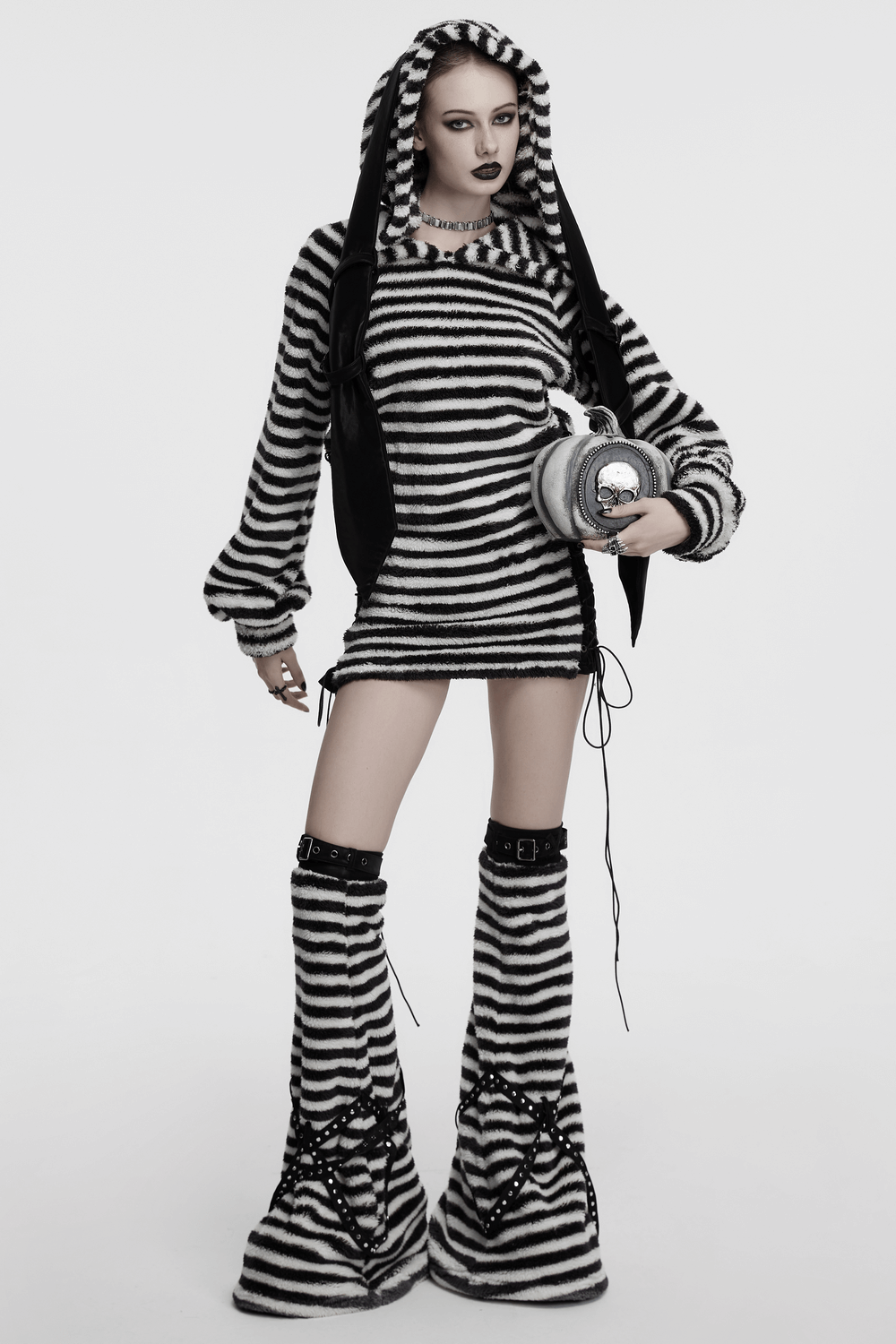 Chic striped plush leg warmers with cross straps paired with a cozy striped hoodie dress, showcasing edgy fashion.