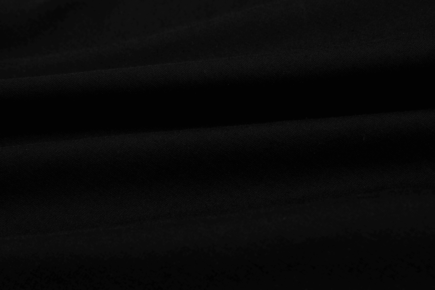 Soft black fabric close-up, perfect for a chic V-neck dress with a sleek silhouette and high slit.