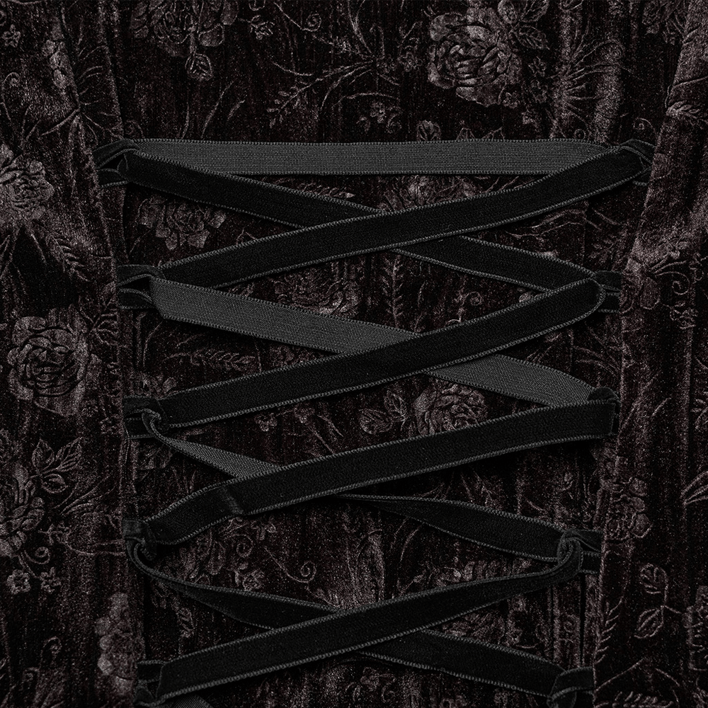 Close-up of adjustable corset lacing on chic velvet dress with rose embossing and gothic texture.