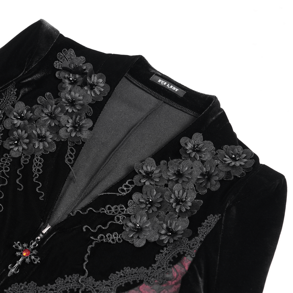 Close-up of gothic velvet dress with intricate black floral embroidery and lace details, showcasing dark elegance.
