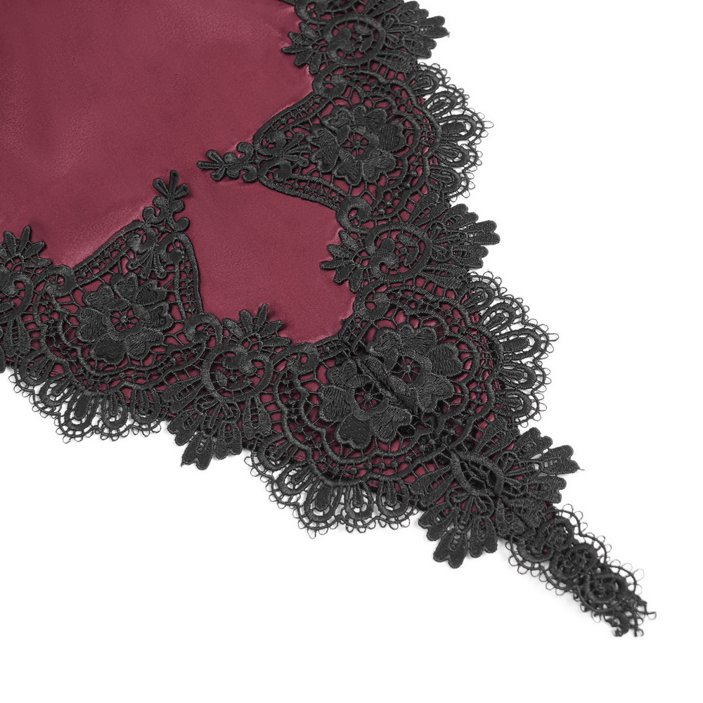 Intricate black lace detailing on wine red fabric, perfect for gothic fashion and evening wear.