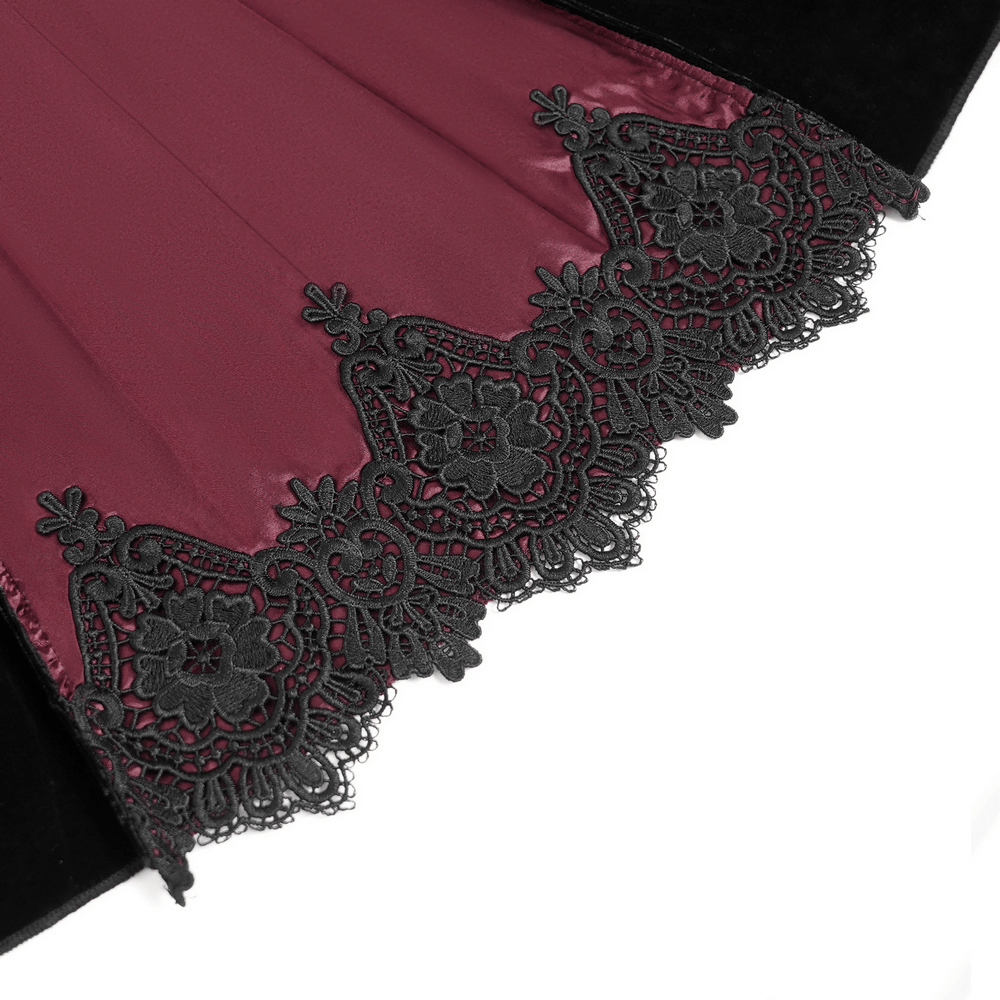 Close-up of wine red fabric with intricate black lace detailing for gothic evening dress.