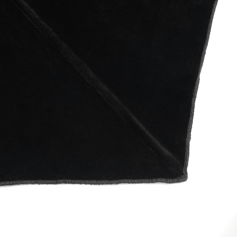 Close-up of luxurious black velvet fabric with a soft texture and elegant sheen.