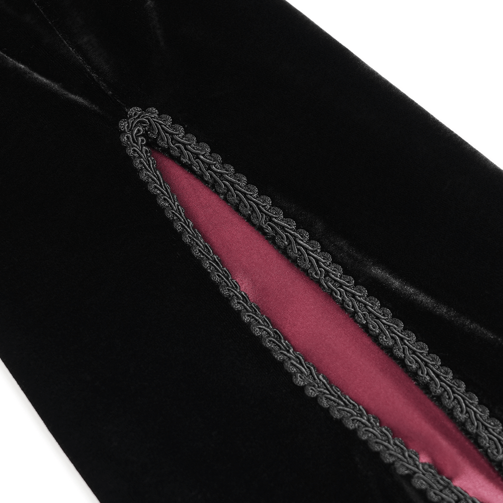 Close-up of dark velvet evening dress showing deep front slit with wine red lining and intricate lace details.