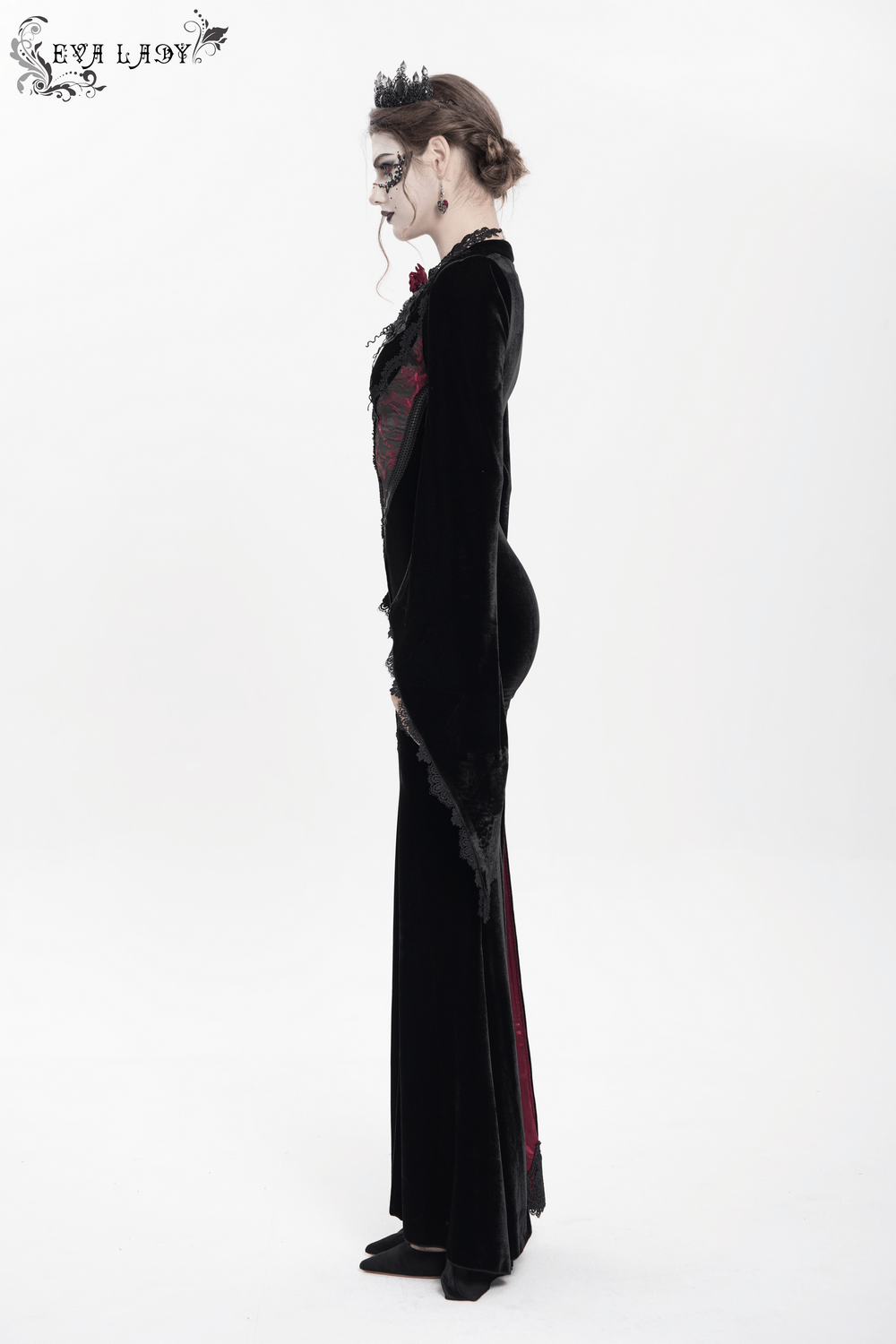 Model showcasing a chic velvet evening dress with lace details and wine red accents.