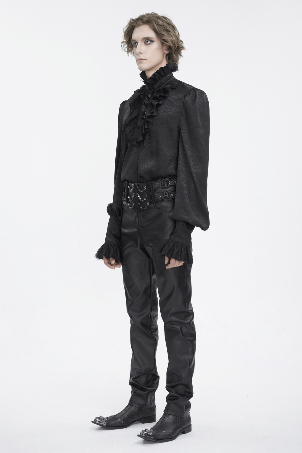 Chic black lace blouse with ruffled neckline and tassel sleeves, paired with sleek black trousers for a stylish look.