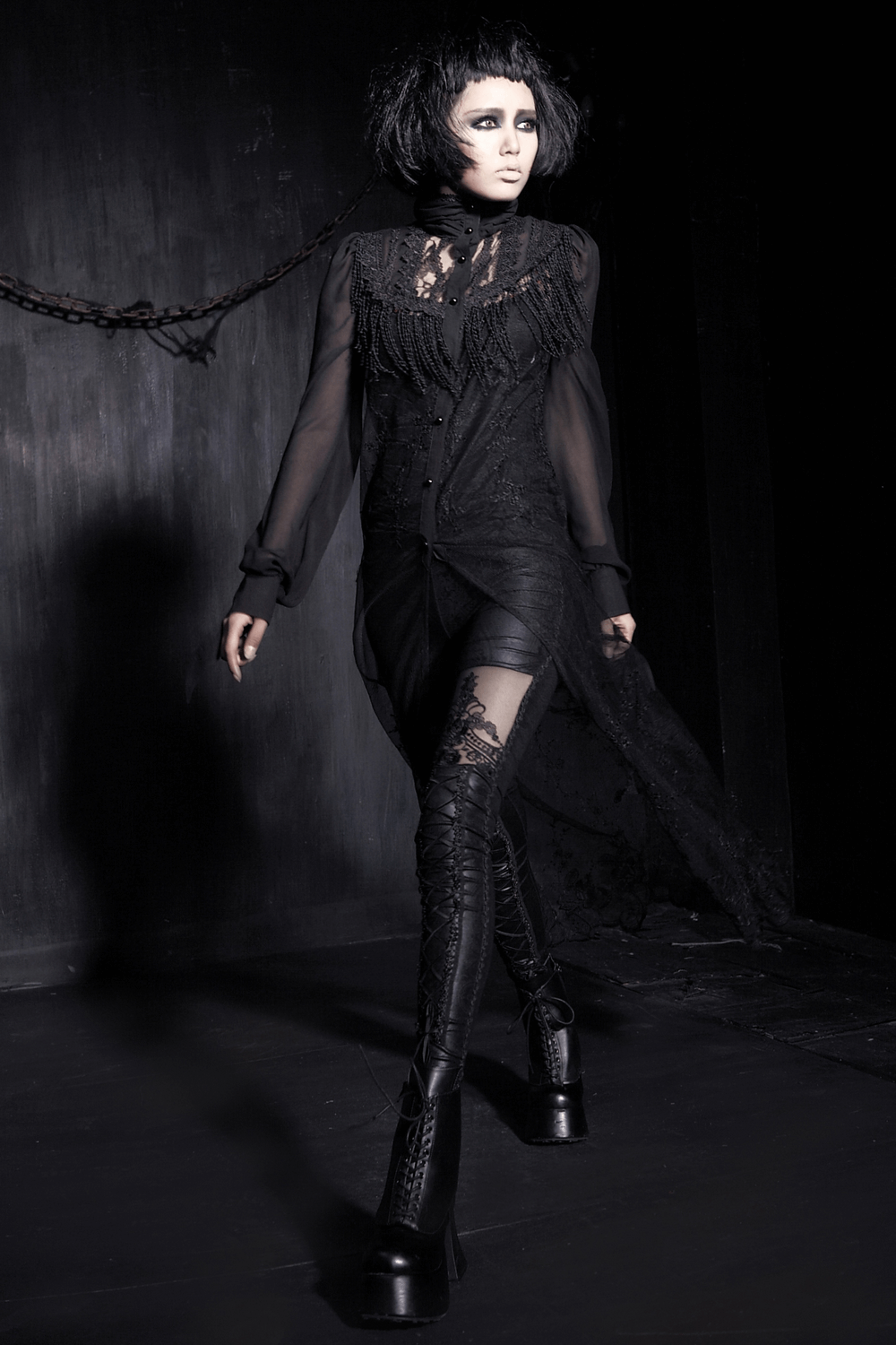 Chic model showcasing elegant black leggings with lace detailing and glossy finish, perfect for modern trendsetters.