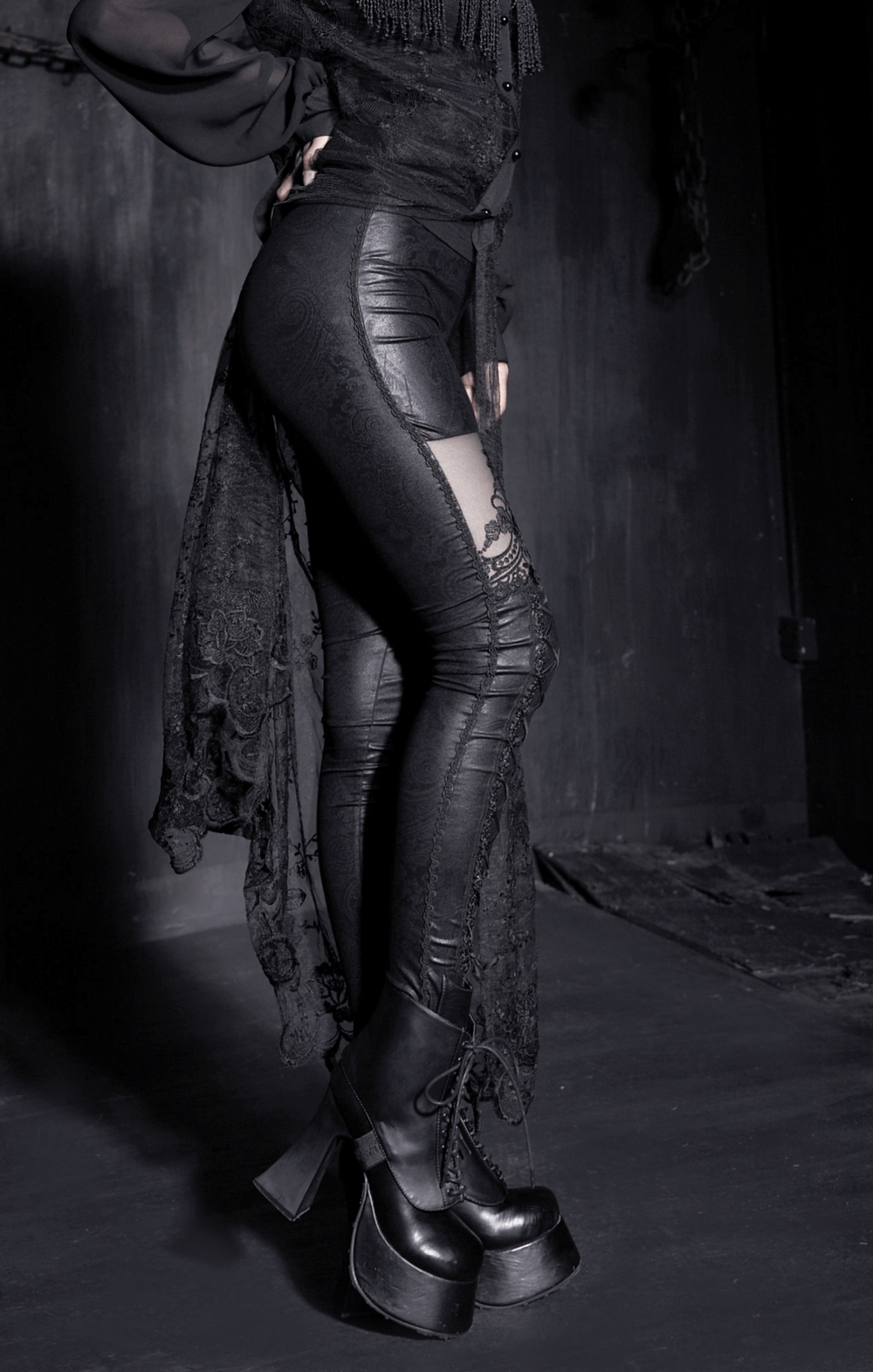 Sleek black flocking leggings with intricate lace details and stylish lace-up, perfect for modern fashionistas.