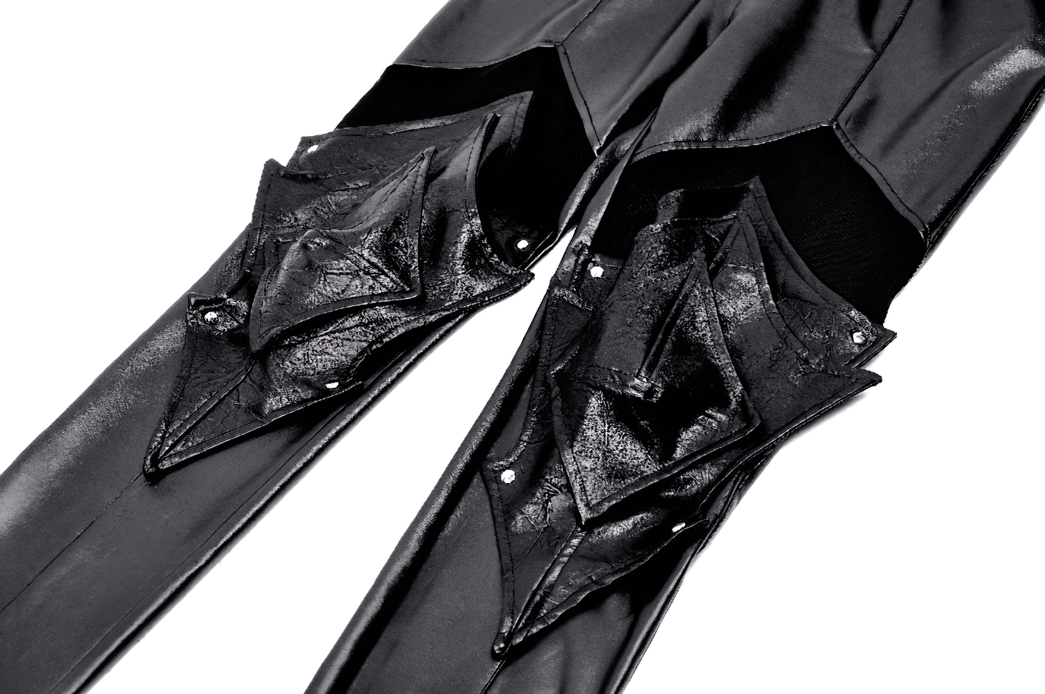 close-up of black PU leather leggings featuring edgy knee armor detailing and stylish mesh panels