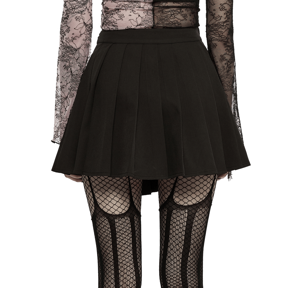 Chic women's punk pleated mini skirt with rivets, paired with fishnet stockings for an edgy look.