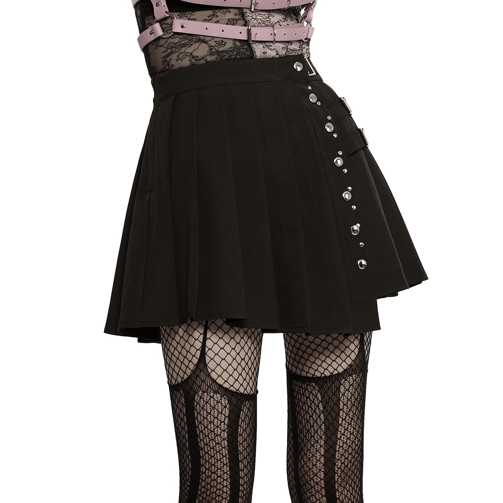 Chic women's black punk pleated mini skirt featuring decorative rivets and stylish pleats for edgy fashion.