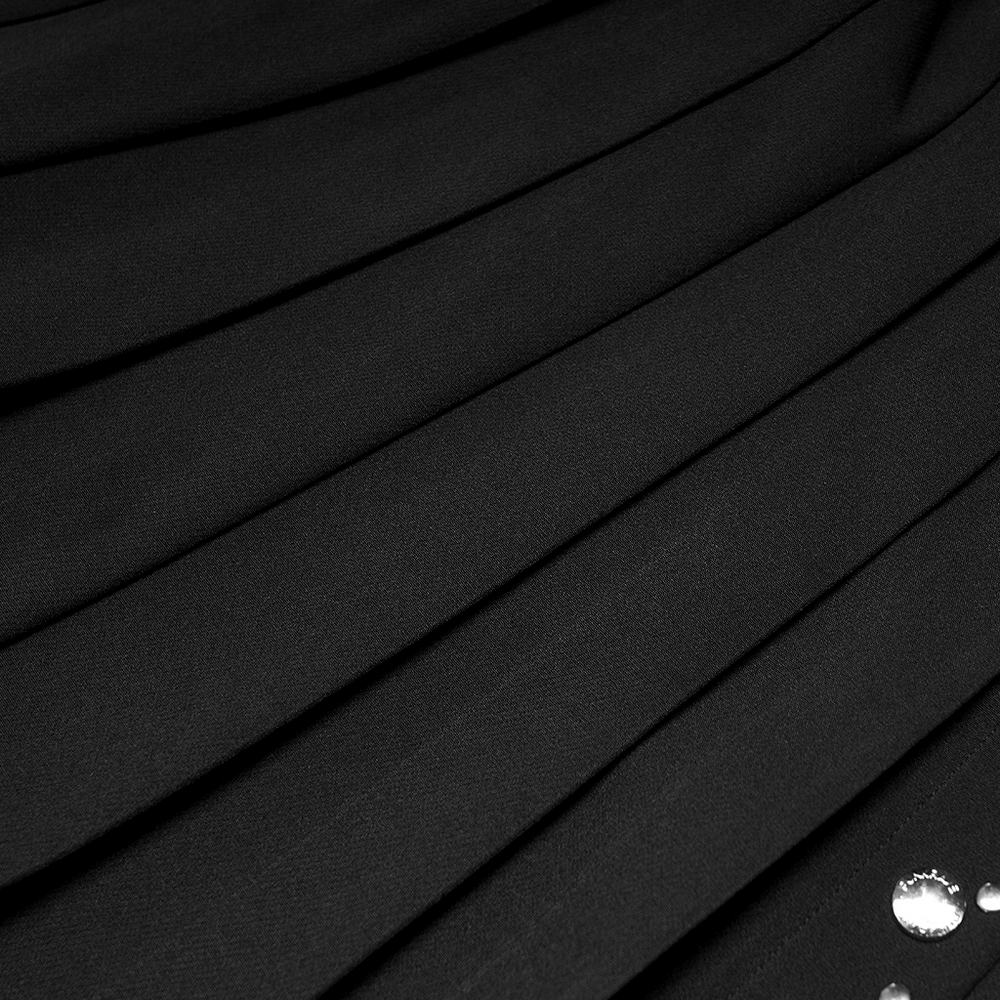 Close-up of trendy black pleated mini skirt with shiny rivets for a chic punk style.