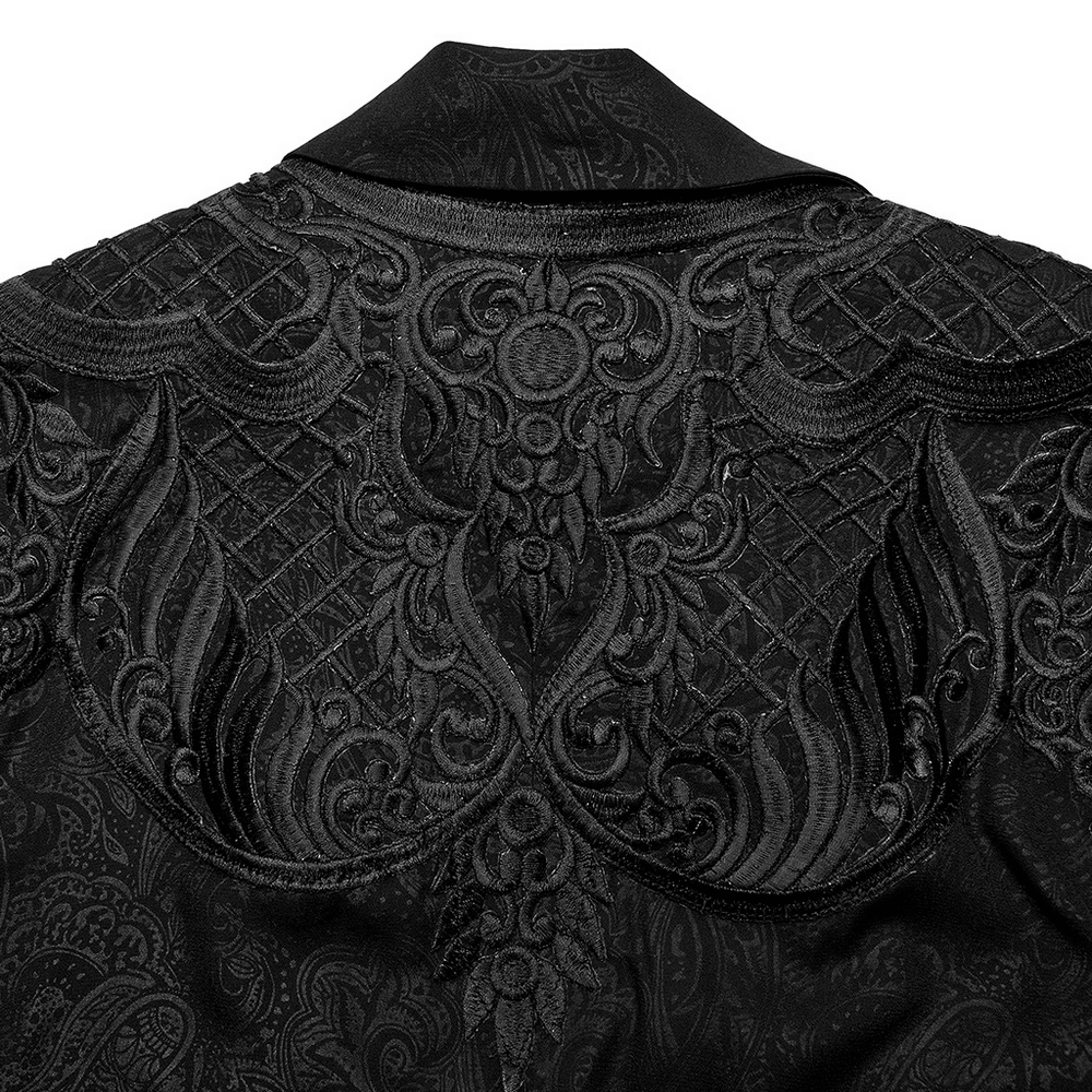 Intricate black lace detailing on the back of a gothic lapel cloak, showcasing elegant patterns and textures.