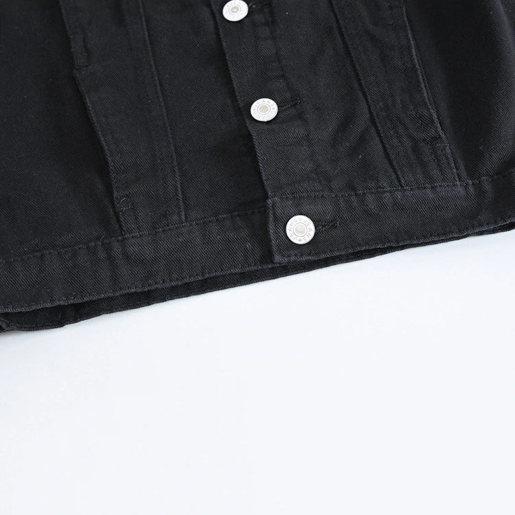 Close-up of black denim vest buttons showcasing stylish design and quality craftsmanship for men's rock fashion.