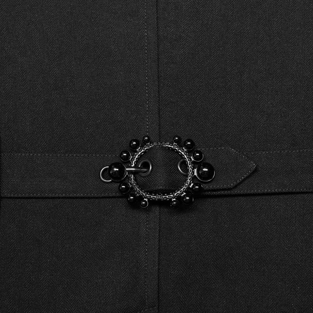 Close-up of black lace-trimmed vest with intricate 3D carved buttons highlighting Gothic design.