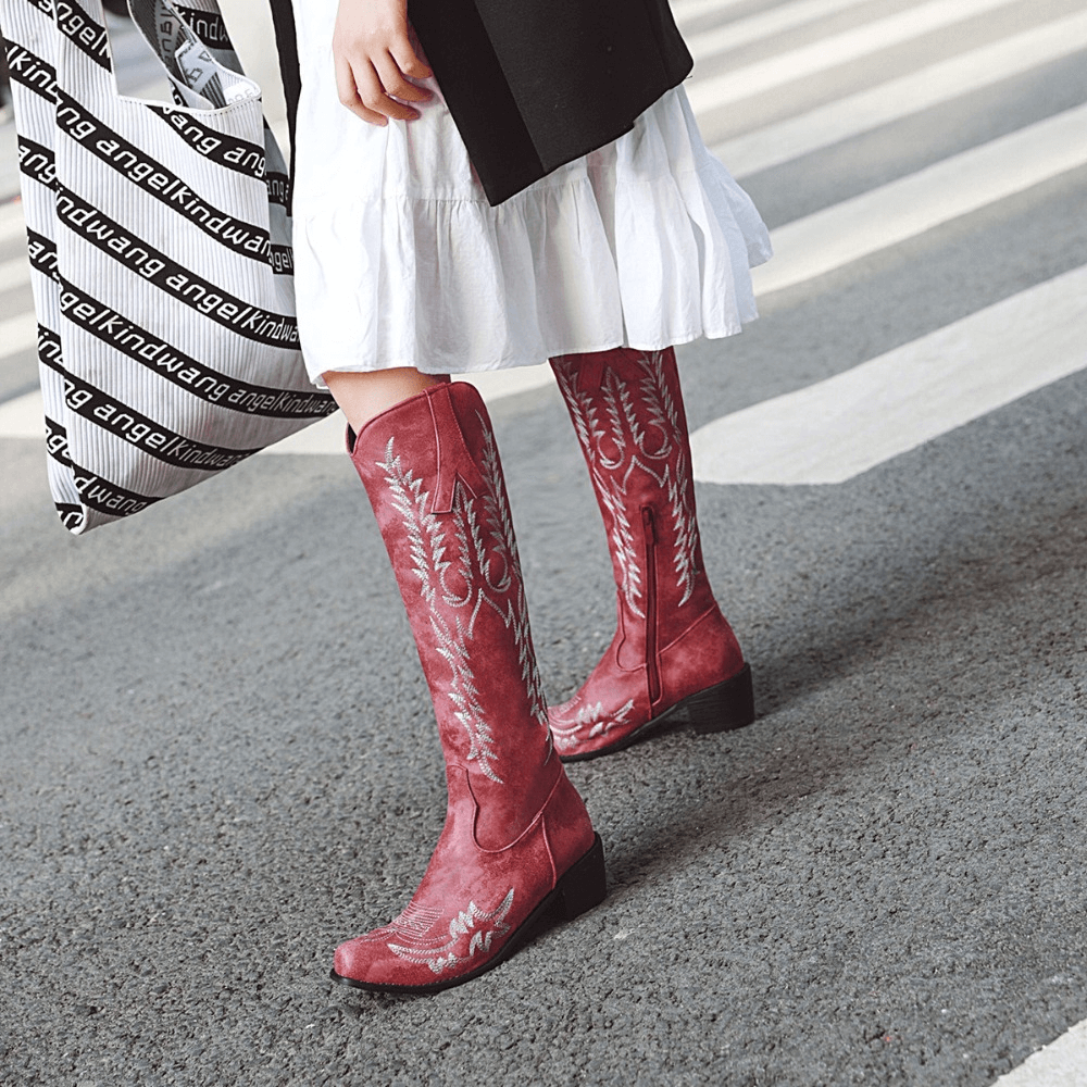 Trendy classic knee-high cowboy boots in red, featuring stylish embroidery, perfect for stylish outfits.