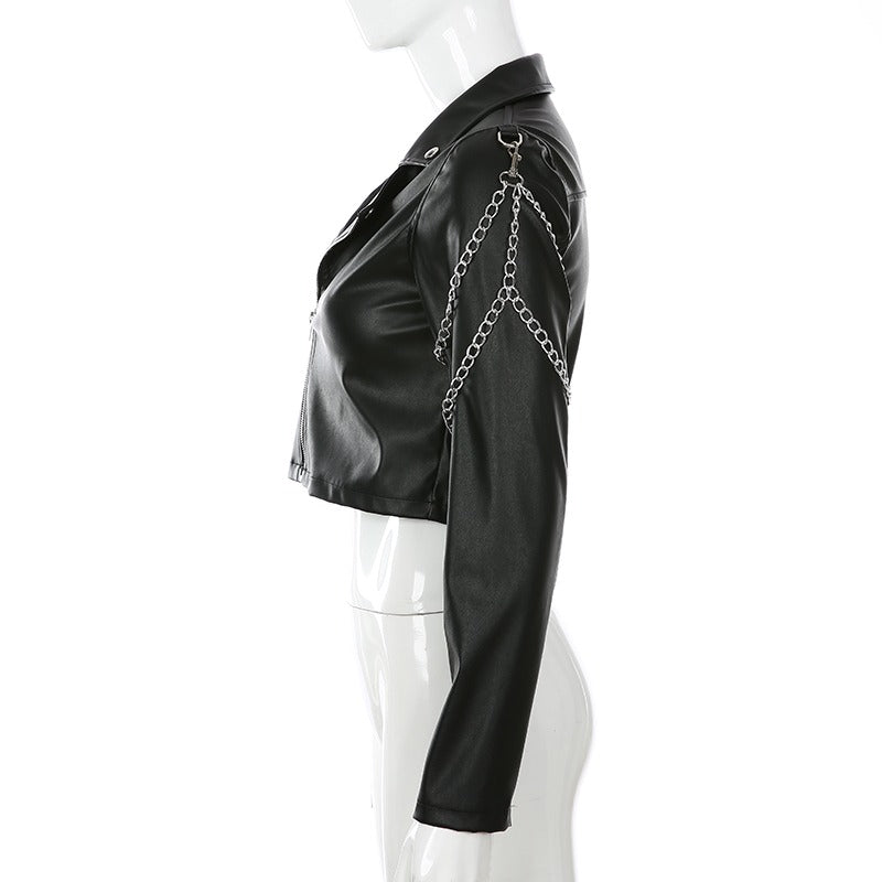 Side view of a black short faux leather motorcycle jacket with chains for women.