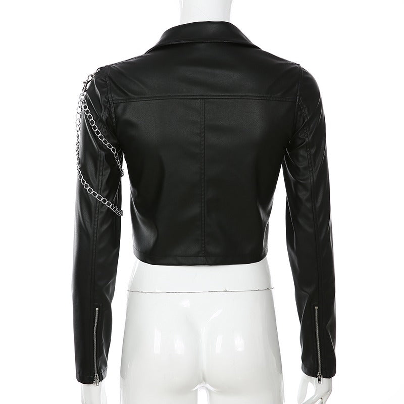 Back view of a black short faux leather women's motorcycle jacket with chain detail.